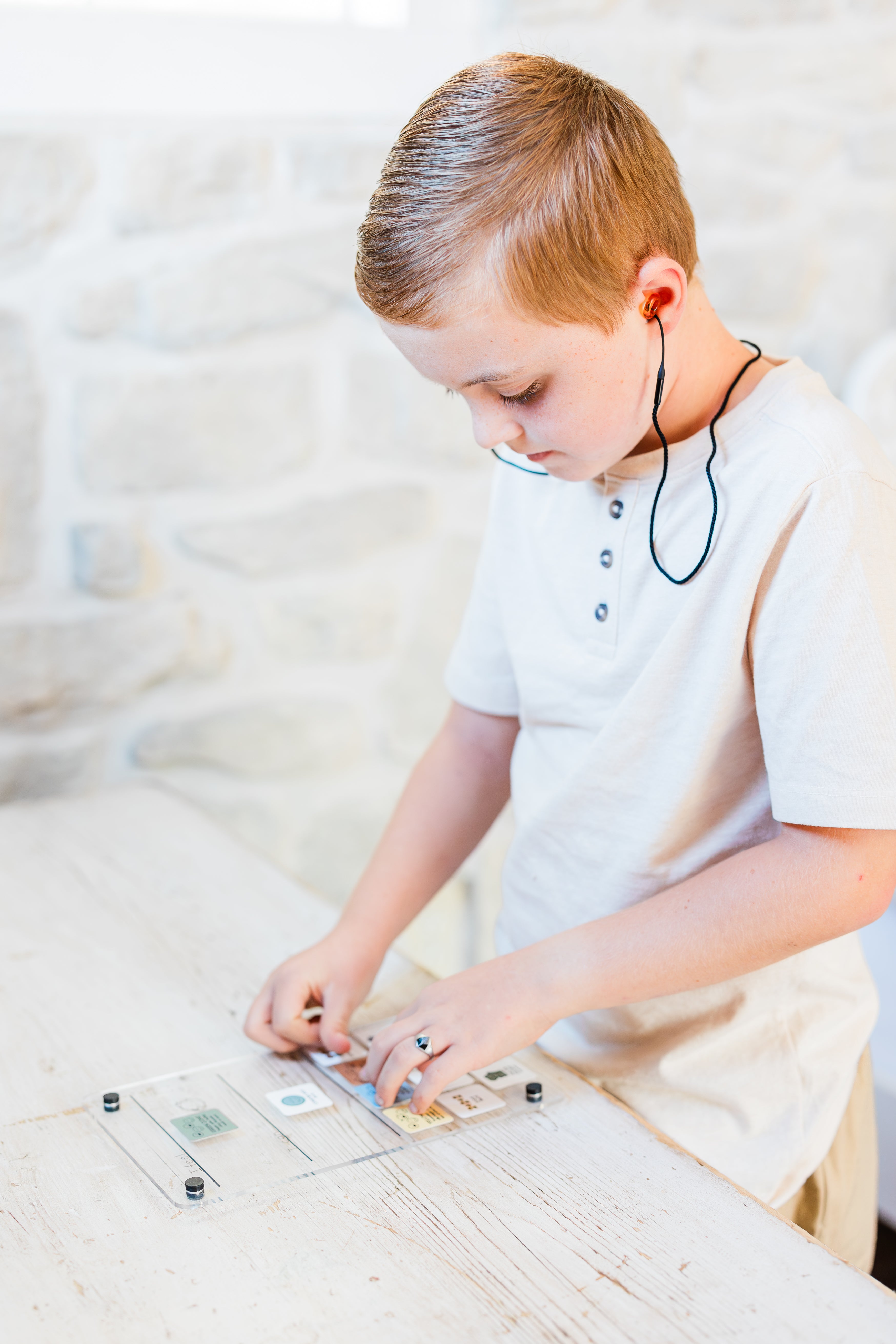 Child using emotion regulation board on a light-colored surface